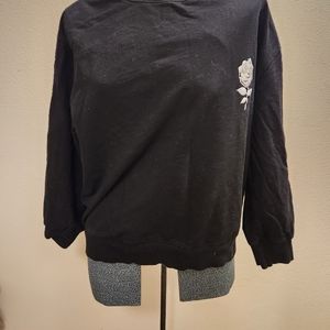 Plain black sweater with rose on front